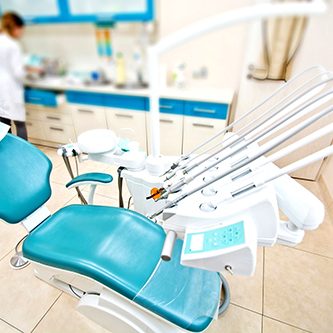 Professional Dentist tools and chair in the dental office. Dental Hygiene and Health conceptual image.